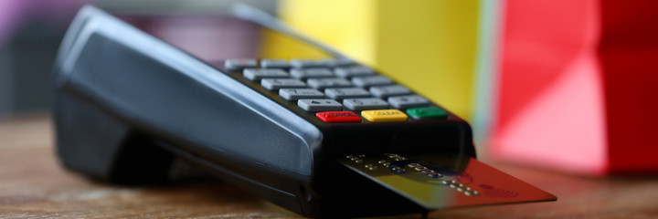 Close-up of terminal with plastic credit card. Cashier machine to withdrawals money. Nfc technology...