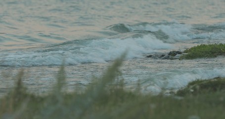 waves break on the beach and rocks, Waves taking down from different angles,