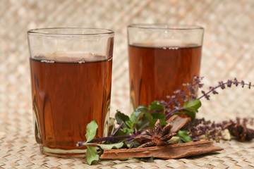 Indian Masala Chai black tea, traditional Tulsi herbal tea beverage with or without milk and spices Kerala India. Two cups organic ayurvedic  herbal drink India, good in winter for immunity boosting.