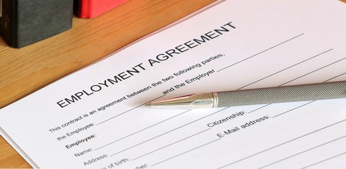 Symbol image: Blank form of an employment agreement on a desk