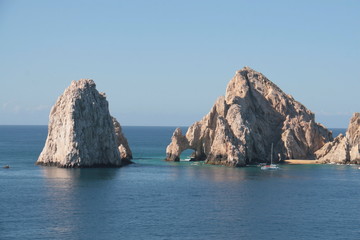 Fototapeta na wymiar rocks in bay of cabo san lucas blue sky and blue water