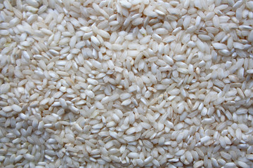 Pile of raw jasmine rice textured background