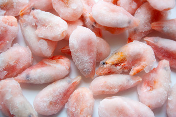 Frozen shrimps on white background close up