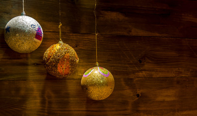 New Year's balls on a dark red wooden background