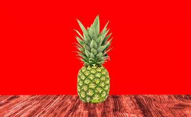 pineapples on a red wooden background and a red background