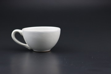 Fototapeta na wymiar Empty white coffee cup on black color background