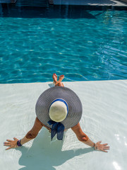 woman in luxury spa resort near the swimming pool.