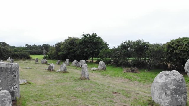 cinematic aerial drone shot of Erdeven standing menhirs: 10 rows of 165 standing menhirs, cut by the road connecting Erdeven to Plouharnel.
