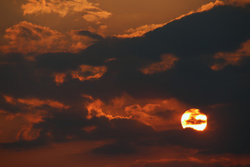 a cloud that looks like it will swallow the sun on halloween