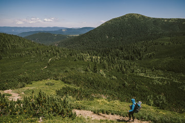 A group of people standing in front of a mountain