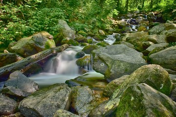 Stream flowing through rocks and a waterfall