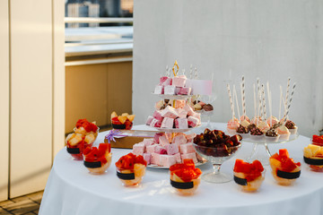 buffet table with sweets and fruits