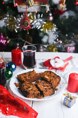 Fototapeta na wymiar Christmas plum cake in Kerala, Indian Christmas celebration background. Homemade cake pieces. Fruitcake made with dried fruit, nuts, spices and rum for New Year party, Easter etc.