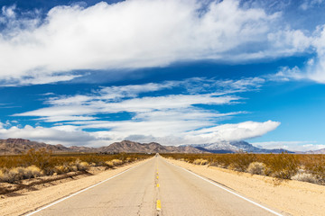 Long Straight Road Running Through a Desert Landscape 