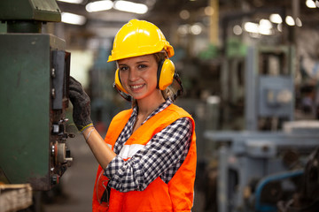 Female Engineer staff operating a cnc machine in factory