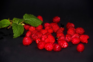 raspberries on a black background