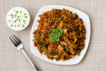 Kothu Parotta a popular South Indian street food in Kerala India made with shredded Porotta, Indian layered bread and egg, meat or vegetables. Served as snack, lunch, dinner or as a main course dish