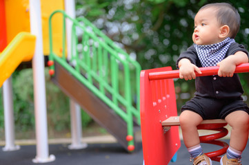 Fototapeta na wymiar Little boy playing on a playground. Kids play on school yard