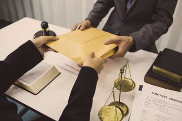 lawyer is presenting an envelope of evidence in the court case.