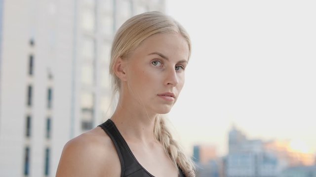 Close-up face of young concentrated woman looking at camera, assertiveness