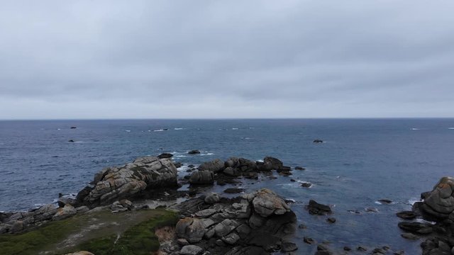 cinematic aerial drone shot of French Bretagne coastal region near Menez Ham. Visiting France for a unforgettable moment of romance, and tourism with wind and traditional food.