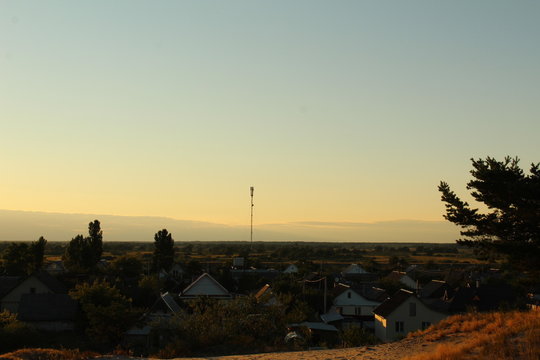 view of the village or city from a height in the evening at sunset postcard picture