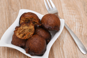Unniyappam, Unni appam traditional Kerala snack sweet food fried in coconut oil for Onam, Vishu festival. made from rice, jaggery, banana, roasted coconut pieces, cardamom