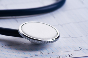 Cardiogram with stethoscope on table, closeup