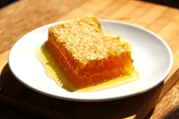 A slice of comb honey on the plate