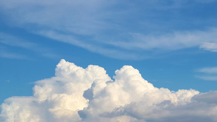 Naklejka na ściany i meble Big white curly cloud in the blue sky