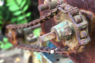 close-up rusty machine gears and chain abandoned in nature