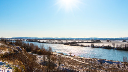Obraz premium Winter landscape with river in sunny weather