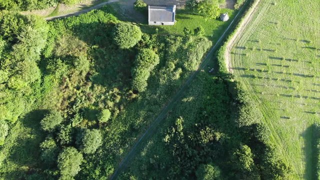 stunning aerial shot of Saint Tromenec Chapelle, founded in the 15th century. The west gable has a fine rose window. in granite formed of six four leaves surrounding a central sixth leaf.