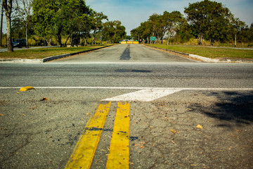 asphalt road with yellow lines