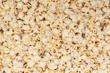 Popcorn background. The background of a scattered pile of salted popcorn.