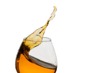 Freeze Action Photography .Splash of Cognac In glass Isolated on White.