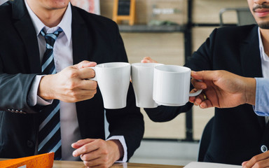 Three businessman have same opinion, rise up a cup and cheer, business concept