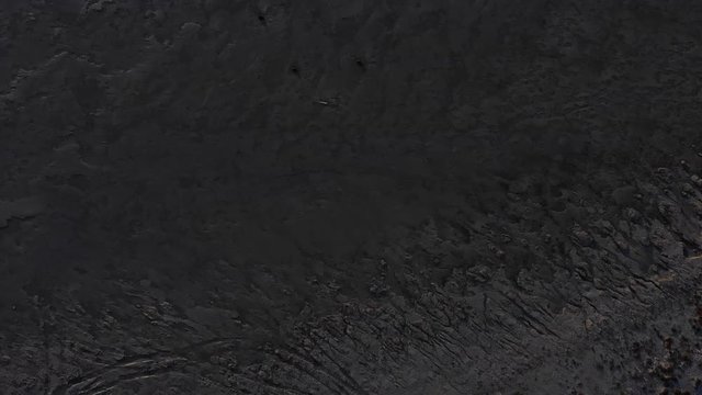 touristic aerial drone shot of black sand beach