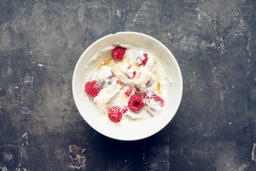 Healthy and tasty breakfast with curd, sour cream, raspberry and honey. Selective focus.