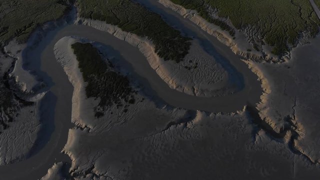cinematic aerial drone shot of vivier sur mer dark sand beach