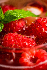 Raspberry and mint cocktail in glass on the rustic background. Selective focus. Shallow depth of field.
