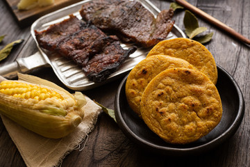 Arepa of yellow corn with oreada or roasted meat. typical food of Colombia
