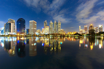 Skyline of Bangkok with reflections in the lake, at the twilight, Thailand