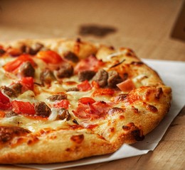 Pizza, close up photo of a delicious pizza with mozzarella cheese, onions, meat, tomato.