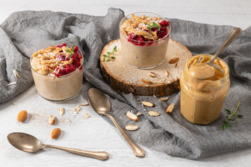 Breakfast oatmeal porridge with raspberries, almond, cinnamon, almond butter and coconut. Healthy breakfast delicious homemade english breakfast concept