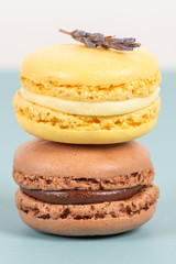 Cake macaron or macaroon on turquoise background from above, colorful almond cookies, pastel colors, vintage card