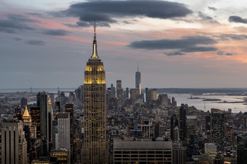 Fototapeta na wymiar Manhattan Skyline Lighting Up At Sunset