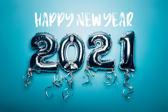 Happy New Year words and Balloon Bunting for celebration of New Year 2021 made from Silver Number Balloons. Holiday Party Decoration or postcard concept, on blue background