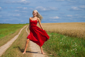 portrait of a young beautiful blonde woman in red dress