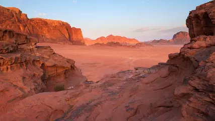 Wall murals Coral Wadi Rum desert landscape in Jordan with mountains and dunes at sunrise